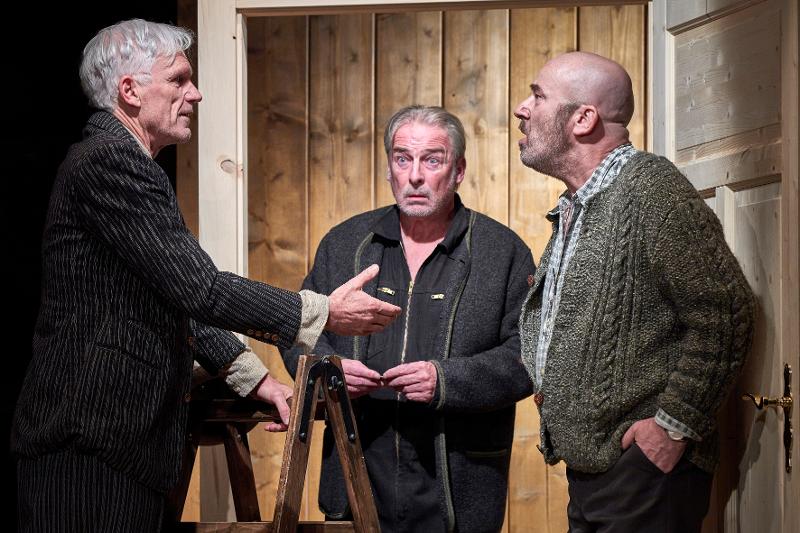 Drei Schauspieler in einer Bauernstube