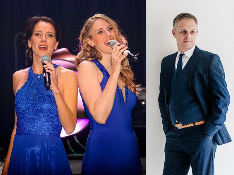 Die zwei Sängerinnen Beatrix Reiterer und Melanie Gebhard, daneben ein Bild von Wolfgang Fischer im Anzug Die zwei Sängerinnen Beatrix Reiterer und Melanie Gebhard, daneben ein Bild von Wolfgang Fischer im Anzug